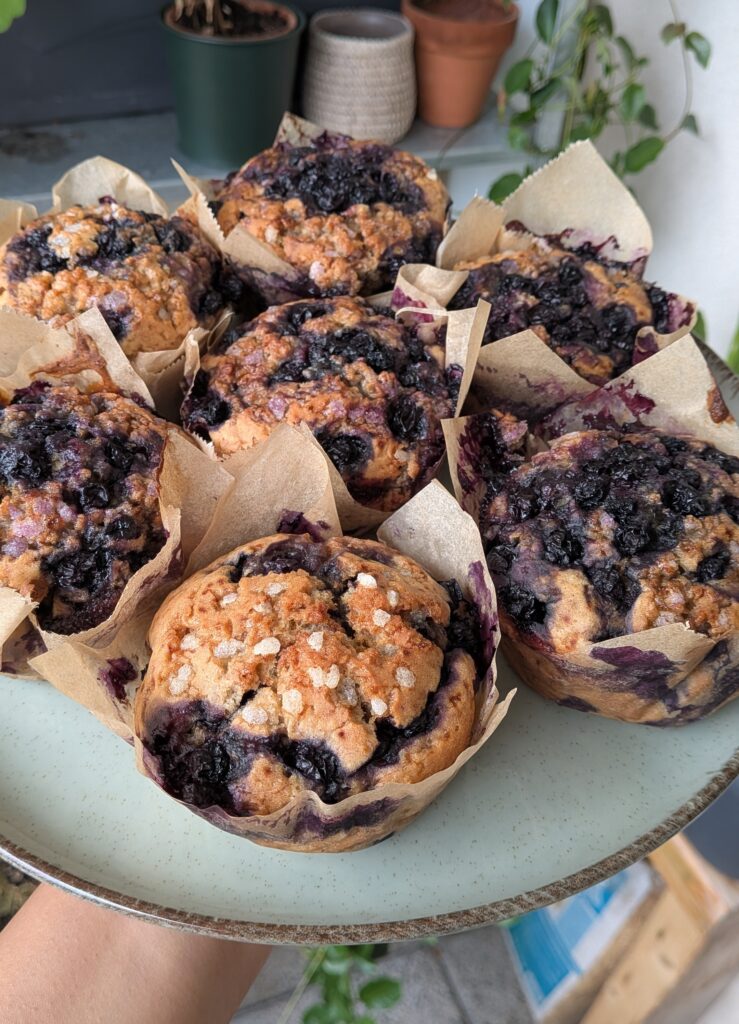 Blueberry Muffins Recipe – Method 2: Made with Butter, Freshly baked blueberry muffins made with butter, golden tops, juicy blueberries bursting inside, tender and fluffy crumb, muffins cooling on a wire rack, home-baked breakfast treat, natural light