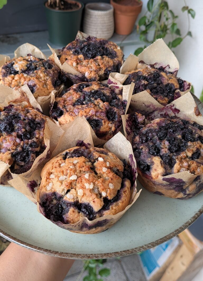 Blueberry Muffins Recipe – Method 2: Made with Butter, Freshly baked blueberry muffins made with butter, golden tops, juicy blueberries bursting inside, tender and fluffy crumb, muffins cooling on a wire rack, home-baked breakfast treat, natural light