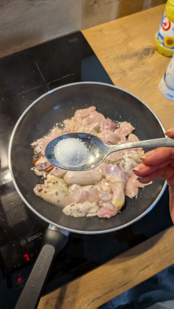 Nepali chicken curry in a traditional bowl with fresh cilantro and scallion garnish, Close-up of bone-in chicken pieces in thick tomato gravy, Step-by-step frying chicken in a heavy-bottomed pan with spices, Grinding ginger-garlic with powdered spices in a mortar and pestle, Adding tomatoes and ground spices to the chicken curry, Finished Nepali chicken curry served with steamed rice and roti, Garnishing chicken curry with fresh cilantro and scallions, Nepali Chicken Curry (Kukhura Ko Masu) – A Home-Style Recipe From My Roots, saru's diary, saru's not so secret diary, nepali food , nepali food blog, food around the world, chicken recipes around the world