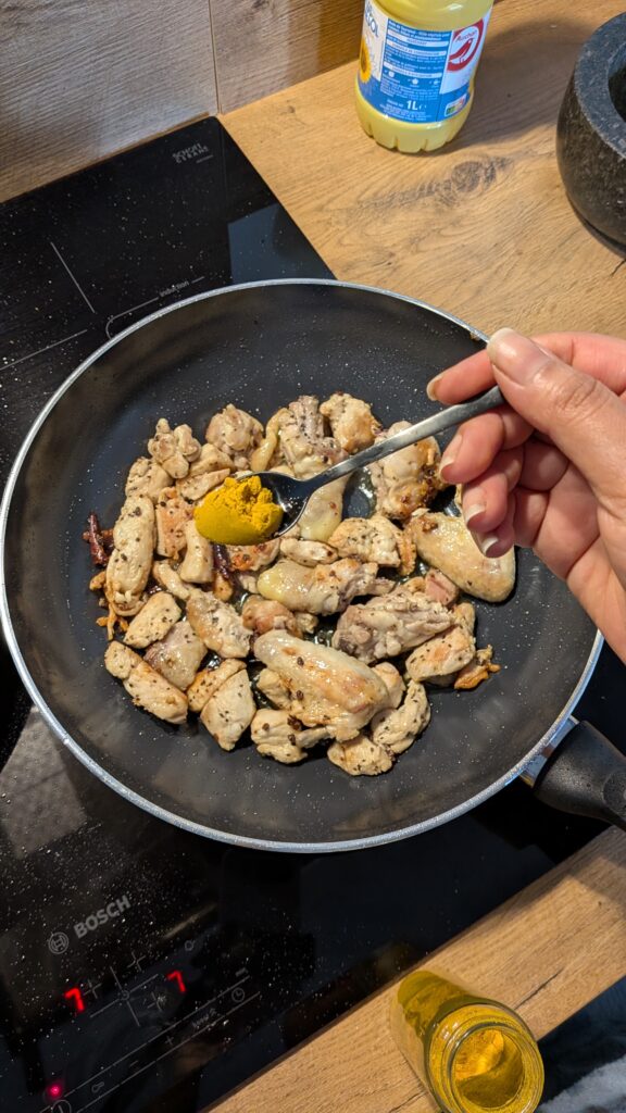 Nepali chicken curry in a traditional bowl with fresh cilantro and scallion garnish, Close-up of bone-in chicken pieces in thick tomato gravy, Step-by-step frying chicken in a heavy-bottomed pan with spices, Grinding ginger-garlic with powdered spices in a mortar and pestle, Adding tomatoes and ground spices to the chicken curry, Finished Nepali chicken curry served with steamed rice and roti, Garnishing chicken curry with fresh cilantro and scallions, Nepali Chicken Curry (Kukhura Ko Masu) – A Home-Style Recipe From My Roots, saru's diary, saru's not so secret diary, nepali food , nepali food blog, food around the world, chicken recipes around the world