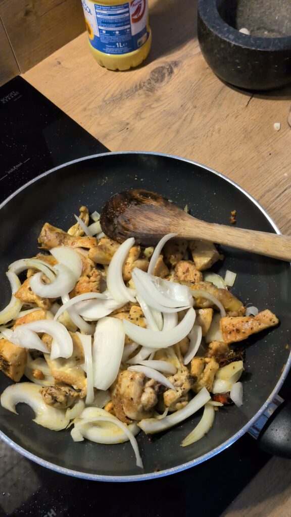 Nepali chicken curry in a traditional bowl with fresh cilantro and scallion garnish, Close-up of bone-in chicken pieces in thick tomato gravy, Step-by-step frying chicken in a heavy-bottomed pan with spices, Grinding ginger-garlic with powdered spices in a mortar and pestle, Adding tomatoes and ground spices to the chicken curry, Finished Nepali chicken curry served with steamed rice and roti, Garnishing chicken curry with fresh cilantro and scallions, Nepali Chicken Curry (Kukhura Ko Masu) – A Home-Style Recipe From My Roots, saru's diary, saru's not so secret diary, nepali food , nepali food blog, food around the world, chicken recipes around the world